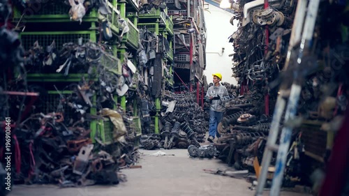 Auto mechanic selecting spare parts from storage shelves in industrial workshop, vehicle maintenance repair process in garage, engineering workflow inventory inspection in automotive service facility.