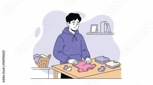 Happy Young Man Dressed in Hoodie Folding Clean Laundry at Home, Completing Household Chores