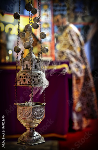 Ornate Silver Incense Burner with Rising Smoke Before Priest at Altar in Serene Church Interior. Vertical orientation with copy space.
