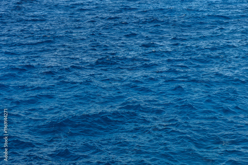 Gentle waves lapping against the shore on a sunny afternoon at an idyllic coastal location.