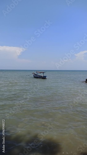Wallpaper Mural A serene scene of fishing boats resting at the dock while the tide rises, with calm water surrounding the vessels and reflecting a quiet coastal atmosphere filled with daily maritime life. Torontodigital.ca