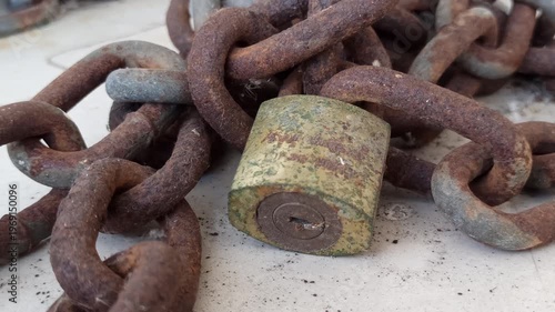 Wallpaper Mural A sturdy chain and padlock used for security, highlighting protection, safety, and reliable locking in a simple setting. Torontodigital.ca