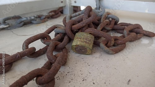 Wallpaper Mural A sturdy chain and padlock used for security, highlighting protection, safety, and reliable locking in a simple setting. Torontodigital.ca