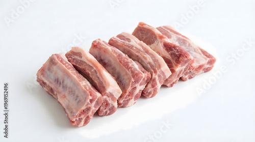 Raw pork rib pieces on a white background