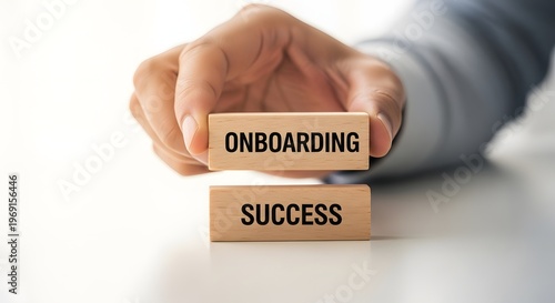 Onboarding and Success Concept: Hand Holding Wooden Blocks
