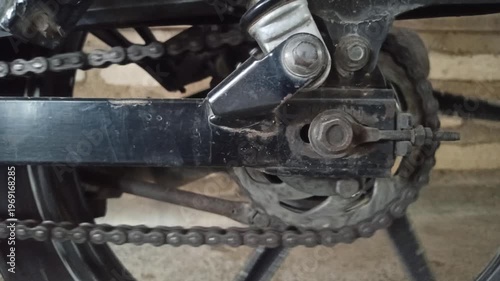 Wallpaper Mural A motorcycle chain on an underbone bike transfers engine power to the rear wheel, highlighting its function, durability, and role in smooth riding performance. Torontodigital.ca