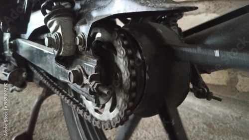 Wallpaper Mural A motorcycle chain on an underbone bike transfers engine power to the rear wheel, highlighting its function, durability, and role in smooth riding performance. Torontodigital.ca