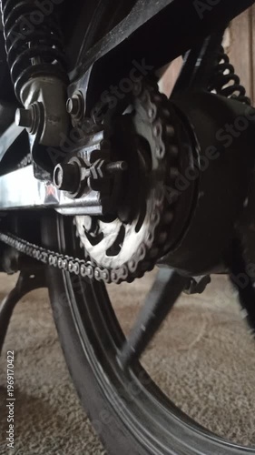 Wallpaper Mural A motorcycle chain on an underbone bike transfers engine power to the rear wheel, highlighting its function, durability, and role in smooth riding performance. Torontodigital.ca