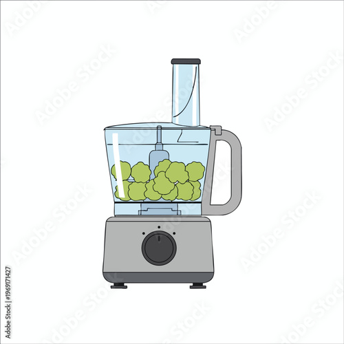 Food processor with green food pieces inside a transparent jug