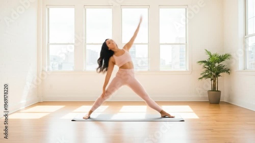 A woman in pink activewear practicing yoga on a mat in a bright room with a plant. Perfect for wellness, fitness, and yoga classes.