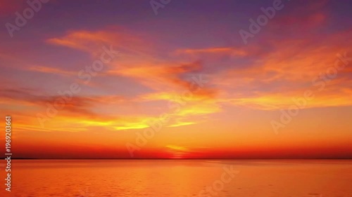a calm landscape with golden clouds moving slowly over mountains 