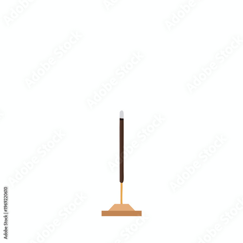 Brown incense stick with light tip on wooden base