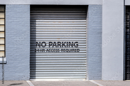 фотографія “No Parking – 24HR Access Required” sign on a metal roller door in Melbourne, Australia