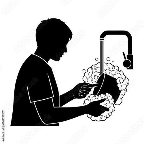 Silhouette of a person washing dishes under running water with soap bubbles