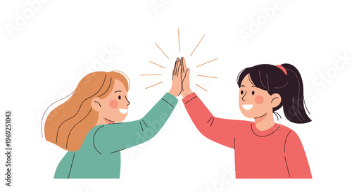 Two young girls smiling and giving each other a high five to celebrate a success or friendly agreement.