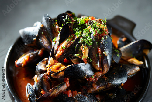 Tomato mussel soup in a pot