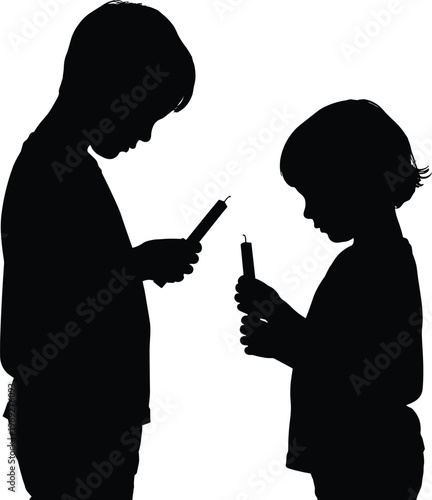 Silhouettes of two children engrossed in their smartphones