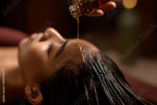 A woman receiving a head spa treatment. An image evoking relaxation through esthetics, cosmetic medicine, and scalp care.