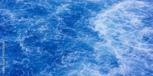 Abstract the ocean's vast surface transforms into a captivating spectacle. Capturing the dynamic dance of water in all its splendor. 