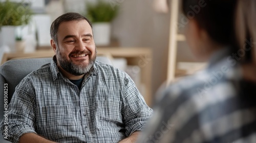 A man smiling during a therapy session with a counselor