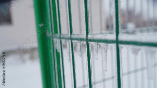 Wallpaper Mural Icicles hanging from green mesh fence close-up harsh winter Torontodigital.ca