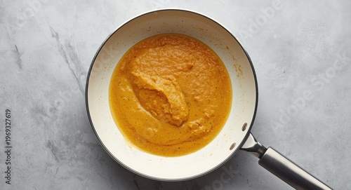 White frying pan and pumpkin pancake batter shown stepwise in flat lay