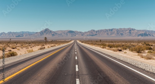 Straight and polished highway crossing desolate desert environment
