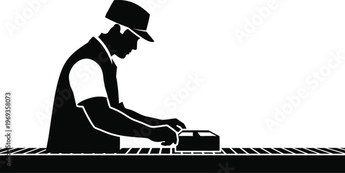 Black and white silhouette of a man working with a machine