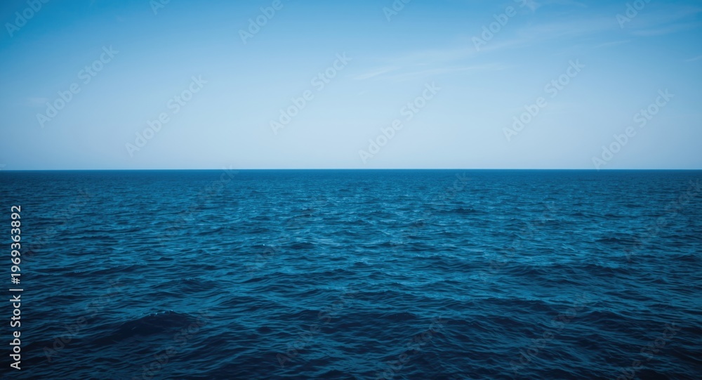 Obraz premium Tranquil ocean scene with deep blue waters and clear skies