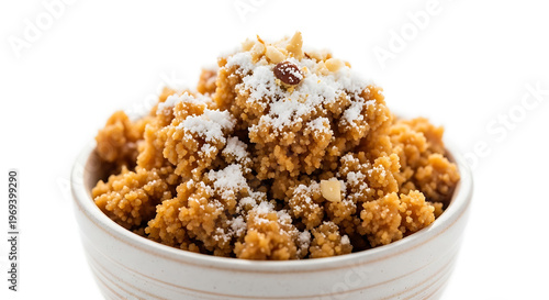 Traditional Rajasthani Churma sweet dish served in a white ceramic bowl, topped with powdered sugar and chopped nuts. A classic Indian dessert often paired with Dal Baati, 
