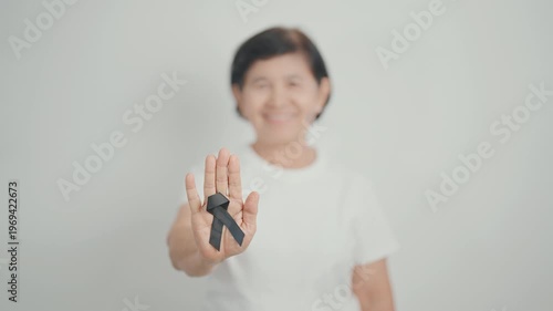 Elderly with Black ribbon for May Melanoma and skin cancer Awareness month, October Vaccine injury awareness month, Mourning Remembrance, March Sleep awareness week, Gang Prevention and Anti Violence