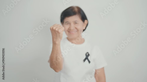Elderly with Black ribbon for May Melanoma and skin cancer Awareness month, October Vaccine injury awareness month, Mourning Remembrance, March Sleep awareness week, Gang Prevention and Anti Violence