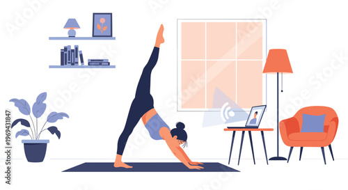 Woman practicing yoga in a split pose at home while following an online fitness class on her laptop in a cozy modern living room.