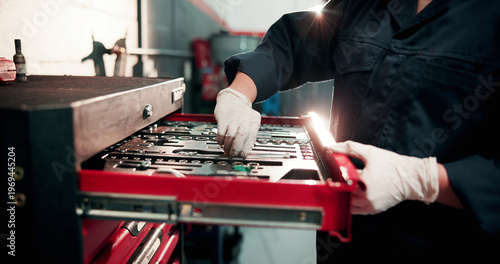 Tools, drawer and hands of mechanic in garage for auto service, maintenance and vehicle repair. Workshop, technician and person with metal equipment for motor industry, inspection and fixing engine