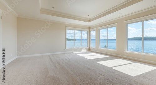 Traditional rambler room showcasing light carpet and ceiling with outdoor lake panorama