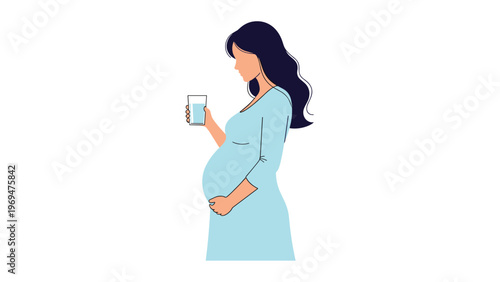 Profile view of a pregnant woman in a light blue dress holding a glass of fresh water to stay hydrated for her babys health.