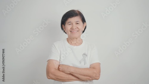 Elderly with Gray ribbon for May Brain Cancer Awareness month and Asthma Awareness, Support life people Survivor. Healthcare and February World cancer day