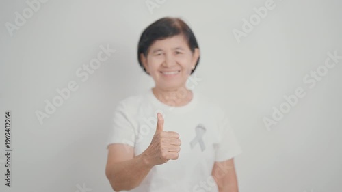 Elderly with Gray ribbon for May Brain Cancer Awareness month and Asthma Awareness, Support life people Survivor. Healthcare and February World cancer day