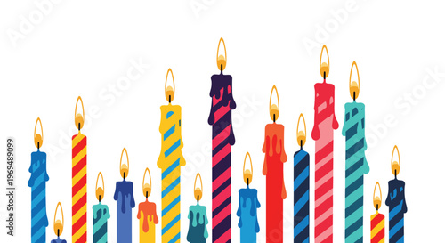 Wide variety of colorful birthday cake candles with different stripe patterns and melting wax, all lit with bright glowing flames.