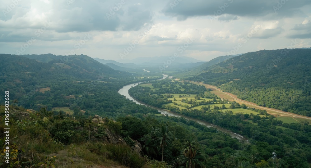 Obraz premium Wide Open Valley with a Meandering River and Lush Vegetation