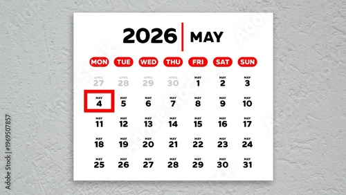 The date May 4th marked with a red cursor on a wall calendar 2026