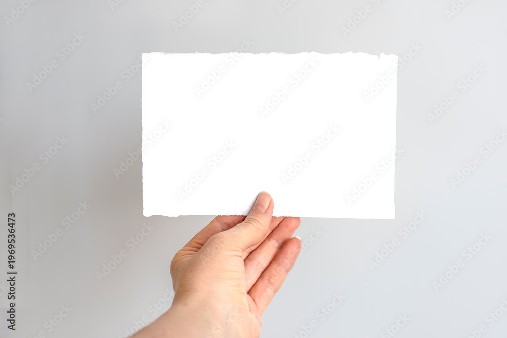 Obraz premium Hand Holding Torn Grid Paper.