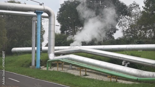 Wallpaper Mural Large piping system with steam emissions outdoors, illustrating industrial processes and energy production. Torontodigital.ca