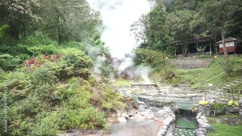 Wallpaper Mural Steam rising from a water source in a natural environment with dense trees, concept of geothermal activity and natural beauty. Torontodigital.ca