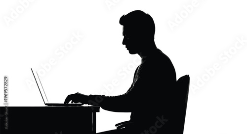 A striking silhouette captures a diligent individual intently focused while working on a laptop at a desk, embodying the modern professional's dedication and concentration in a sleek, high-contrast bl