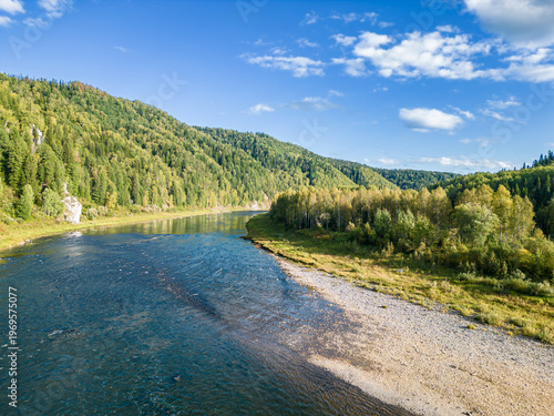 Vászonkép Shallow river with dangerous rocks seen from drone warning inexperienced tourist
