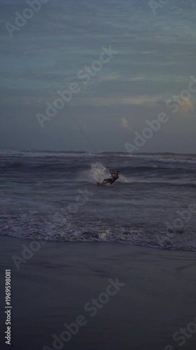 Kiteboarder with Kite Line Surfing Waves at Canggu Beach Bali Evening