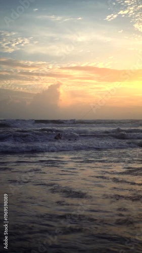 Distant Kiteboarder in Ocean Waves at Sunset Canggu Beach Bali