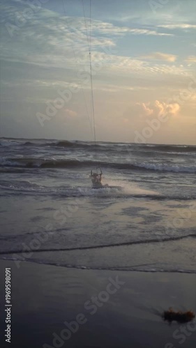 Kiteboarder Jumping in Air over Ocean Waves at Canggu Beach Bali