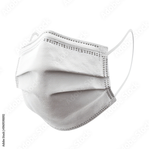 A white surgical face mask on a black background